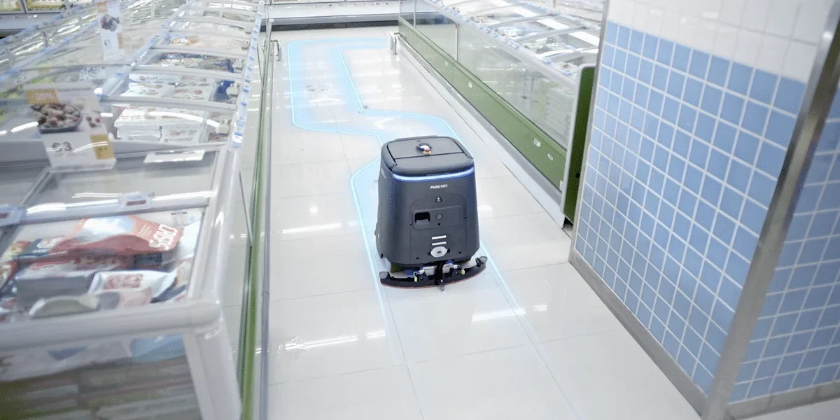 PUDU commercial cleaning robots on a clean showroom background